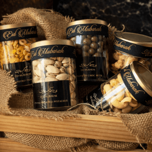 Eid Mubarak luxury snack jars with cashews, trail mix, and chocolate nuts – premium Eid gift set.